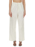 Woman wearing Victoria Beckham white wide-leg trousers