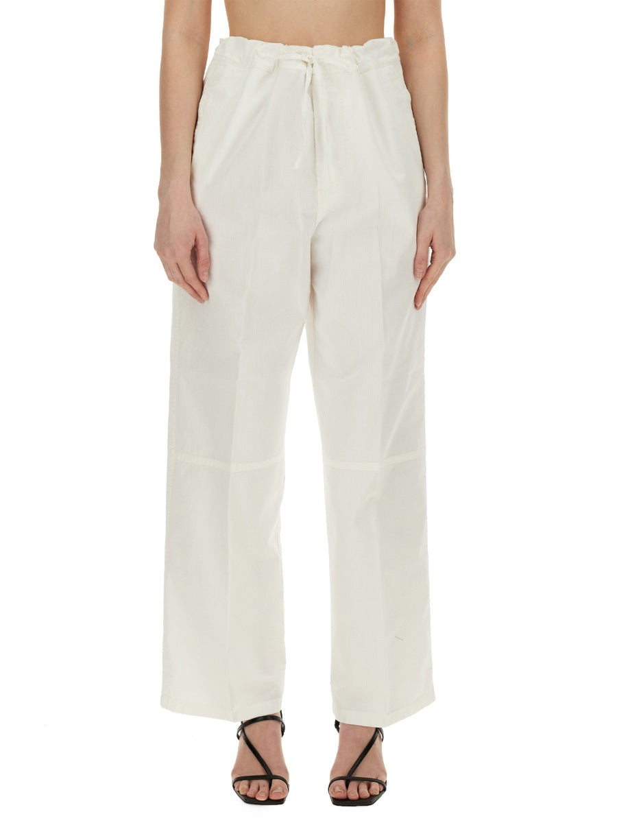 Woman wearing Victoria Beckham white wide-leg trousers